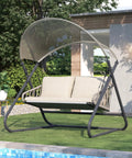 Two-Seat Outdoor Porch Swing With Canopy, Hanging Glider Bench With Thick Cushions, Rustproof Metal Frame, Water Resistant, Beige Patio Hammock Lounge Chair For Backyard Garden Deck, Cozy Vibe Patio Set shown on lawn