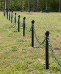 Top Shelf Plastic Barrier Chain Khaki Gold 500 Foot Spool One Inch Diameter for crowd control with green chain posts in a park.