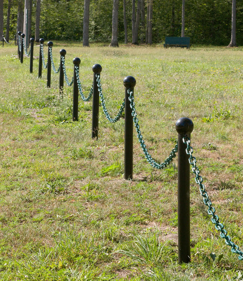 Top Shelf Plastic Barrier Chain Khaki Gold 500 Foot Spool One Inch Diameter for crowd control with green chain posts in a park.
