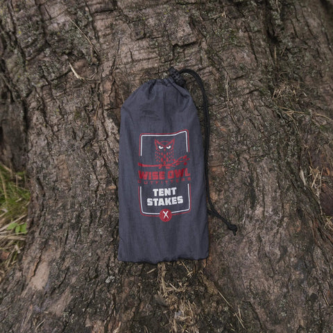 Beefy 16 Pack 7075 Aluminum Tent Stakes 7.25 Inch Long Heavy Duty Ground Pegs in carry bag on tree trunk