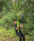 Child using Backyard Zipline Trolley With Brake Race Car Style Handlebars in a wooded area, demonstrating stability and safety features.