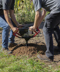 Two operators using Earth Auger Combo With 52cc Two Cycle Powerhead And 8 Inch Auger Included Heavy Duty Handlebars Model 58630 on soil