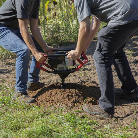 Two operators using Earth Auger Combo With 52cc Two Cycle Powerhead And 8 Inch Auger Included Heavy Duty Handlebars Model 58630 on soil
