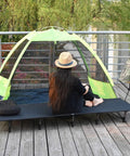 Ultralight Folding Camping Cot Bed For Outdoor Travel Portable And Compact Base Camp Ready Perfect For Hiking Mountaineering And Lightweight Backpacking In Black Go To Durable Rugged Comfort For A Restful Sleep Anywhere on wooden deck beside tent and chair