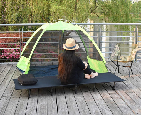 Ultralight Folding Camping Cot Bed For Outdoor Travel Portable And Compact Base Camp Ready Perfect For Hiking Mountaineering And Lightweight Backpacking In Black Go To Durable Rugged Comfort For A Restful Sleep Anywhere on wooden deck beside tent and chair