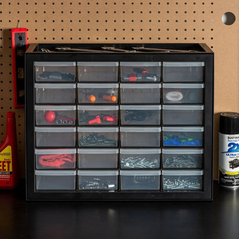 24 Drawer Plastic Storage Organizer Cabinet For Garage Tools Beads Crafts Balloons Building Bricks Stickers And Small Biz Supplies Durable Black Storage Organizer Made In USA For Easy Centralized Tidying on a workbench with drawers filled with small items