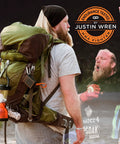 Man hiking with backpack and Ultra Bright LED Camping Lantern With 800 Lumens, Battery Powered Emergency Light attached to side.