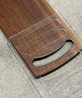Six In One Charcuterie Board Handle Template Acrylic Router Guide placed on a wooden cutting board for carving smooth grips.