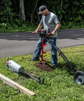 Man using 60V Cordless Dirt Auger with 8 Inch High Performance Bit near road, grass, and tools; drilling hole in lawn.