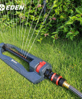 Sprinkler connected with Premium Garden Hose Quick Connect Set With 5-Piece Snap And Lock Fittings, watering grass