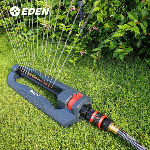 Sprinkler connected with Premium Garden Hose Quick Connect Set With 5-Piece Snap And Lock Fittings, watering grass