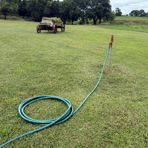Heavy Duty Flexogen Three Quarters Inch By Fifty Foot Garden Hose With Eight Layer Construction And Five Hundred Psi Burst Strength coiled on grass