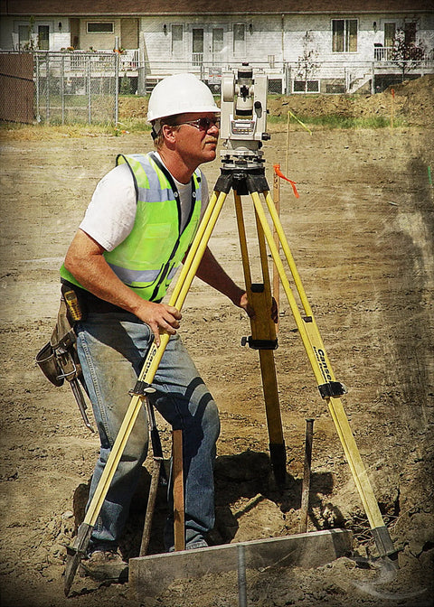 Professional Grade High Visibility Safety Vest Class 2 Reflective Trim Heavy Duty Construction Workwear For Outdoor Crews Safety Green Medium worn by a worker using surveying equipment on a construction site.