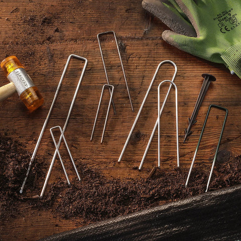 100 Pack 6 Inch 11 Gauge Heavy Duty U Shaped Garden Staples Ground Stakes for anchoring landscape fabric on wooden surface