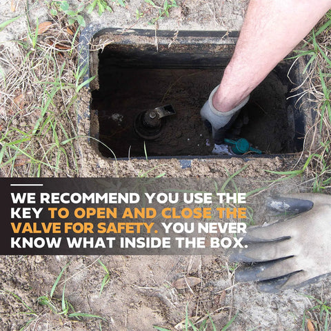 Person reaching into underground meter box with gloved hand near a valve, next to safety instructions text.
