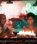 People smiling around a birthday cake under lighting by Smart WiFi LED Light Bulb A19 Millions Of Colors And Tunable White.