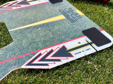 Speed Trap Two Point Zero Golf Swing Trainer polycarbonate base with alignment stripe on grass, Made in USA