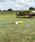 Traveling Sprinkler That Rolls Across Large Lawns Up To 13,500 Sq Ft Cast Iron Outdoor Water Sprinkler in bright yellow on grass