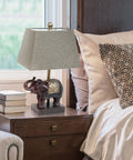Festive Elephant Table Lamp in brown with gold accent resin base on nightstand, 20 inch tall, brown fabric shade, cozy home decor