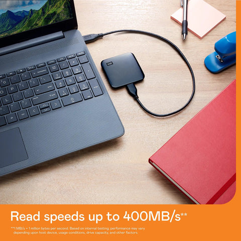 2TB Portable SSD With USB 3 For Quick File Transfers On The Go connected to a laptop for data transfer, ideal for PC and Mac.