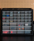 Small Parts Storage Cabinet With 44 Drawer Organizer For Screws Nuts Bolts Electronics Hardware Beads Crafts And More, Built Tough Made In USA Stackable Black Boss Grade on a workbench.