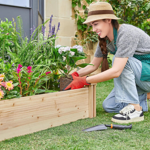Person gardening in Dual Section Divisible Wooden Raised Garden Bed 8 By 2 Feet Elevated Planter Box For Flowers Vegetables And Herbs