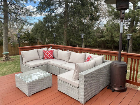 Outdoor deck with wicker sofa set, glass-top table, and Deck Or Fence Mount For Tiki Torches And 1-1/4-Inch Poles Fits Solar Lights Black Outdoor Torch Bracket visible.