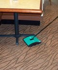 Heavy Duty Manual Rotary Floor Sweeper Featuring Dual Nylon Brush Rolls Seven Point Five Inch Path And Twin Catch Pans in use on carpet.