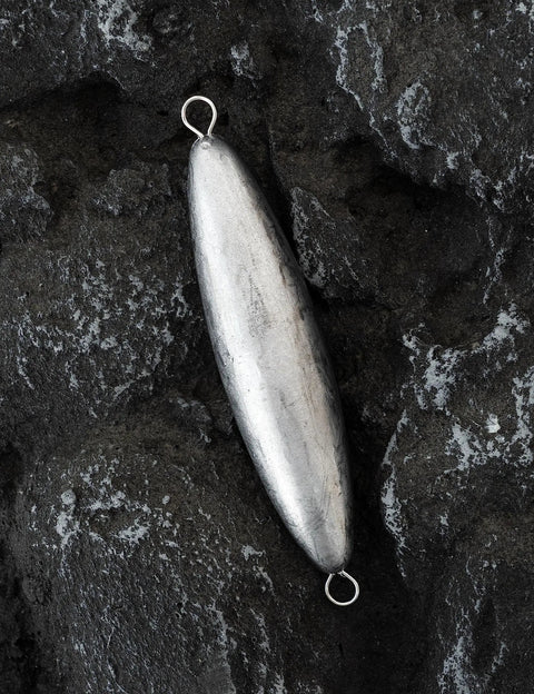 Through Wire Torpedo Sinker Bullet Lead Fishing Weight For Saltwater Double Ringed 16 Oz on rock surface