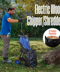 Man using Corded Electric Wood Chipper Shredder Be The Yard Boss With 1.7 Inch Capacity And 15 Amp Motor in garden