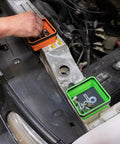 Foldable Magnetic Parts Tray Set For Mechanics showing orange and green trays with fasteners on a car engine