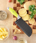 VRUIFA French Fry Cutter, front view, lime-green handle and black ribbed blade on cutting board.