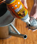 Heavy Duty Waterproof Polyurethane Glue For All Materials That Expands To Create A Bond Like Crazy 18 Ounce Brown Bottle pouring into watering can