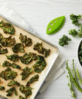 Zero Stress Leaf Stripper For Fresh Kale And Collard Greens With Super Sharp Curved Cutting Edge Quick Herb Chopper next to baked kale chips.