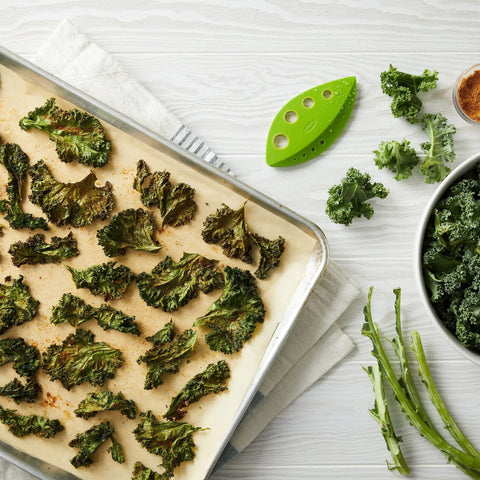Zero Stress Leaf Stripper For Fresh Kale And Collard Greens With Super Sharp Curved Cutting Edge Quick Herb Chopper next to baked kale chips.