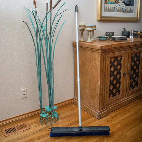 No Nonsense Commercial Floor Sweep With Integrated Squeegee Includes Sixty Inch Three Piece Aluminum Handle And 24 Inch Broom Head on wooden floor.
