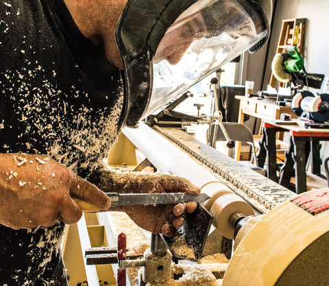 Craftsman using 8 Piece Wood Turning Chisel Set For Lathes Including Skew Spear Point Parting Tool Round Nose in workshop