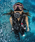 Diver underwater using Pro Dive Regulator System MK25 EVO A700 Carbon Black Tech in open water, bubbles rising.