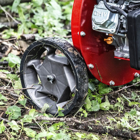 Heavy Duty 301cc Chipper Shredder With 4 Cycle Viper Engine, red frame and airless wheel on brush pile terrain