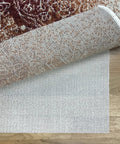 Cream open weave rug pad keeping rugs anchored solid on hardwood or tile floors, showing detail and texture.