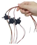 Hand holding Go To Compact 22mm Flange Slip Ring with 2A current rating, conductive ring brush, multiple colored wires visible