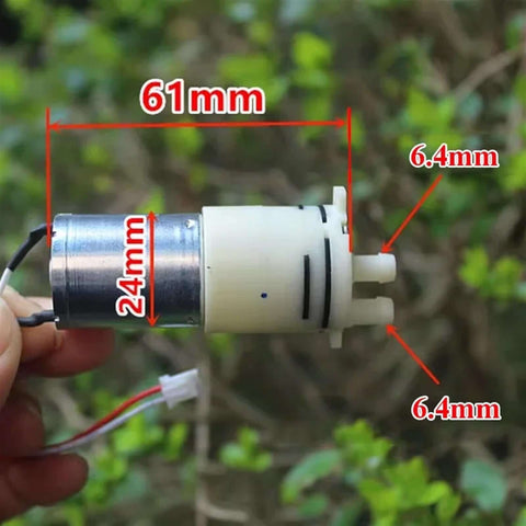 Compact DC 6V 9V 12V Micro 370 Motor Self Priming Diaphragm Water Pump with 24mm diameter and 6.4mm ports, hand-held view