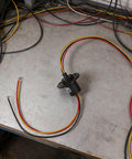 High Current Slip Ring Rotating Connector With 3 Wires 10A 22Mm Diameter placed on a table with colorful wires visible