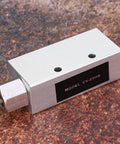 Compact Vacuum Generator For Pneumatic Systems CV 25HS with metal body and precision threads displayed on textured surface.