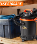 Powerful 2 HP Wet Dry Vacuum With 4 Gallon Tank And Nozzles, compact shop vacuum stored on shelf, black and orange design