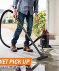 Man using Powerful 2 HP Wet Dry Vacuum With 4 Gallon Tank and Nozzles on wet floor in garage