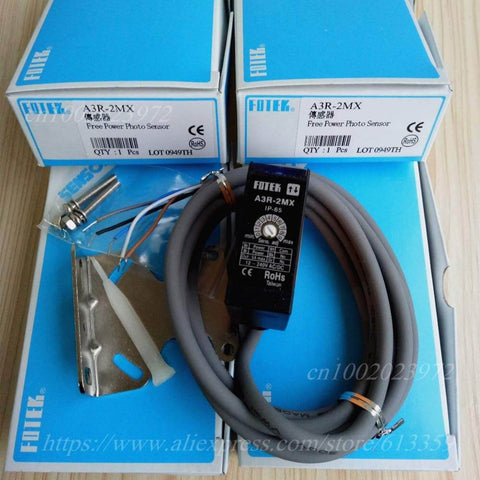 Diffuse Reflection Photoelectric Switch Sensor A3R-2MX with packaging and accessories on a wooden surface