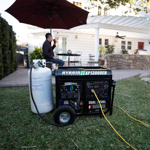 XP13000EH Dual Fuel Portable Generator in backyard setup, connected to propane tank showcasing outdoor use and electric start setup.