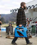 Man carrying Dual Fuel Portable Quiet Inverter Generator With USB Outlet And Parallel Capability, 2,200W Peak, in a camping setting