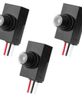 Three black 3-Pack Dusk To Dawn Outdoor Lighting Sensor, 100-277V Weatherproof Photocell Switch shown from various angles.